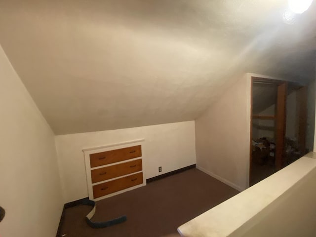 920 16th St, Rockford, IL 61104 - additional living space with vaulted ceiling, baseboards, and dark colored carpet
