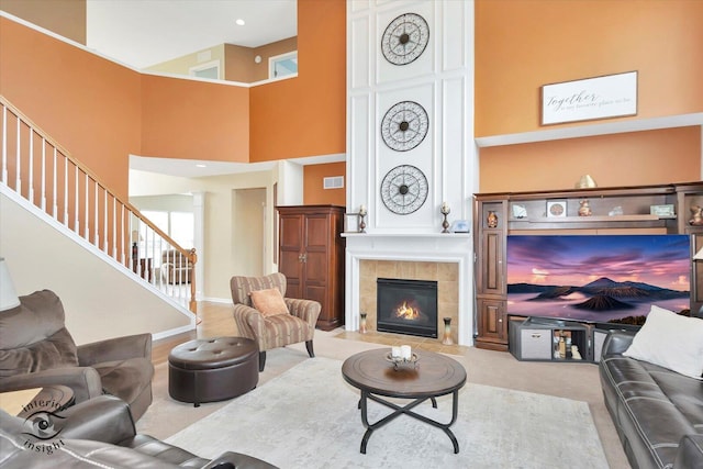 17022 S Creighton Dr, Lockport, IL 60441 - living area featuring stairs, a high ceiling, a fireplace, light colored carpet, and baseboards