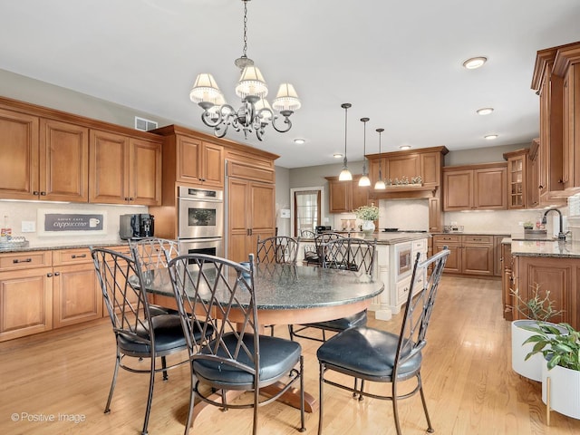 158 Los Lagos Dr, Bloomingdale, IL 60108 - dining room with a chandelier, light wood-style floors, and recessed lighting