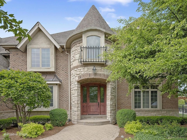 158 Los Lagos Dr, Bloomingdale, IL 60108 - entrance to property with stone siding, a balcony, roof with shingles, and brick siding