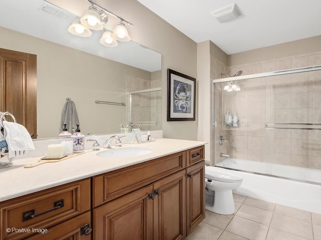 158 Los Lagos Dr, Bloomingdale, IL 60108 - bathroom featuring vanity, tile patterned floors, toilet, and bath / shower combo with glass door