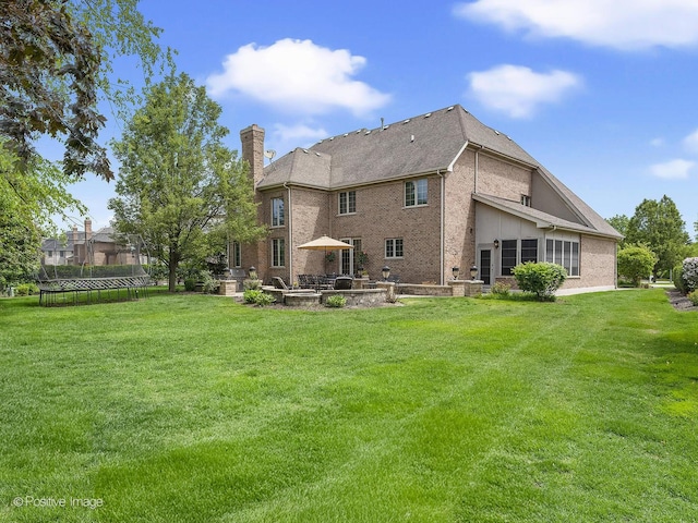 158 Los Lagos Dr, Bloomingdale, IL 60108 - back of house featuring a patio area, a chimney, a yard, and brick siding