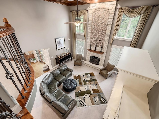 158 Los Lagos Dr, Bloomingdale, IL 60108 - living room featuring healthy amount of natural light, ceiling fan, a stone fireplace, a high ceiling, and stairs
