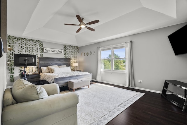 304 Turnbridge Dr, Shorewood, IL 60404 - bedroom featuring a tray ceiling, dark wood finished floors, baseboards, and a ceiling fan