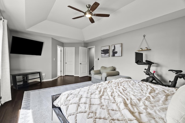 304 Turnbridge Dr, Shorewood, IL 60404 - bedroom featuring a tray ceiling, dark wood-type flooring, baseboards, and a ceiling fan