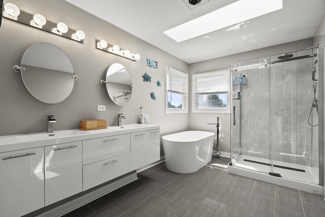 304 Turnbridge Dr, Shorewood, IL 60404 - full bath featuring a shower stall, a soaking tub, double vanity, a skylight, and baseboards