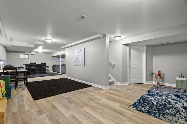 304 Turnbridge Dr, Shorewood, IL 60404 - finished below grade area featuring light wood-style floors, stairs, baseboards, and bar area