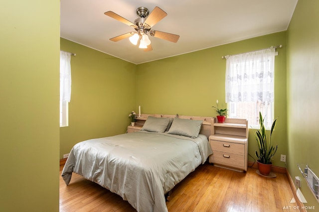 4010 Bobby Ln, Schiller Park, IL 60176 - bedroom with light wood-style flooring, baseboards, and a ceiling fan