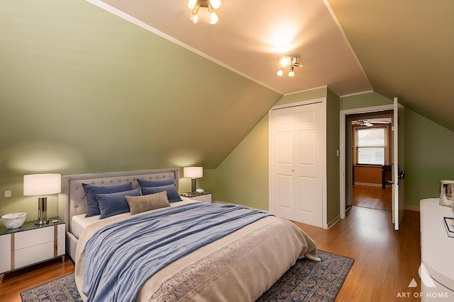 4010 Bobby Ln, Schiller Park, IL 60176 - bedroom with wood finished floors, a closet, vaulted ceiling, and baseboards