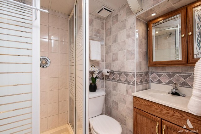 4010 Bobby Ln, Schiller Park, IL 60176 - bathroom with toilet, tile walls, a stall shower, and vanity