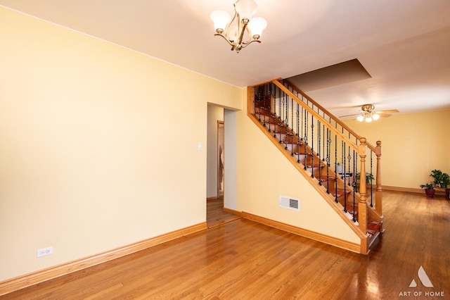 4010 Bobby Ln, Schiller Park, IL 60176 - stairs featuring baseboards, wood finished floors, and a chandelier