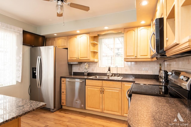 4010 Bobby Ln, Schiller Park, IL 60176 - kitchen with appliances with stainless steel finishes, a sink, a ceiling fan, decorative backsplash, and light wood-style flooring