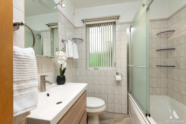 4010 Bobby Ln, Schiller Park, IL 60176 - full bathroom featuring vanity, toilet, tile walls, and shower / bath combination with glass door