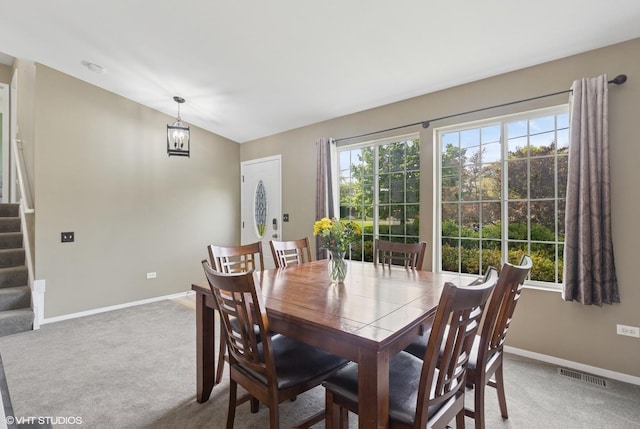 822 Foster Ave, Lake Bluff, IL 60044 - dining area featuring stairway, baseboards, light carpet, and vaulted ceiling