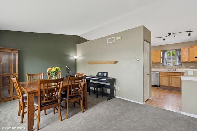 822 Foster Ave, Lake Bluff, IL 60044 - dining space featuring light colored carpet, lofted ceiling, rail lighting, and baseboards
