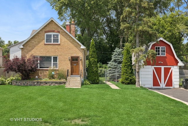 415 W N Blvd, Mchenry, IL 60051 - view of front facade featuring a chimney, brick siding, an outdoor structure, and a gambrel roof
