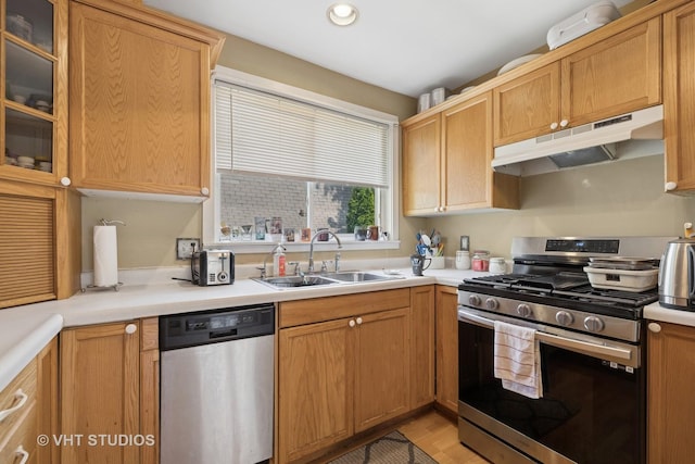 415 W N Blvd, Mchenry, IL 60051 - kitchen featuring appliances with stainless steel finishes, under cabinet range hood, light countertops, glass insert cabinets, and recessed lighting