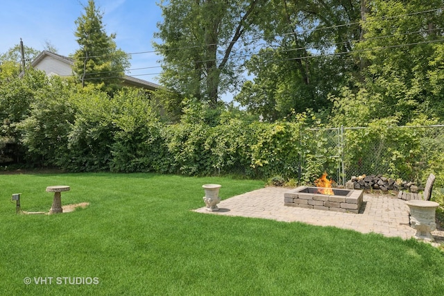 415 W N Blvd, Mchenry, IL 60051 - view of green lawn featuring an outdoor fire pit and a patio area