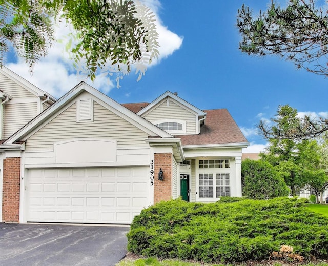 31905 Millard Cir, Warrenville, IL 60555 - view of front of property featuring asphalt driveway, brick siding, an attached garage, and a shingled roof