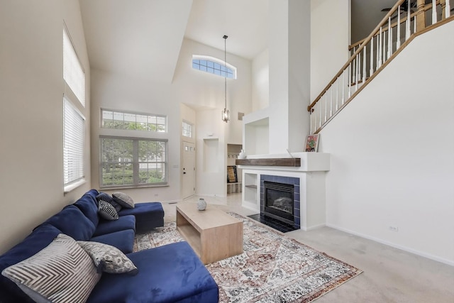 31905 Millard Cir, Warrenville, IL 60555 - carpeted living area featuring a towering ceiling, plenty of natural light, baseboards, a tile fireplace, and stairs