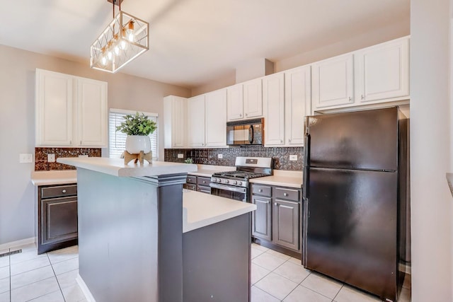 31905 Millard Cir, Warrenville, IL 60555 - kitchen with black appliances, a kitchen island, light countertops, tasteful backsplash, and light tile patterned flooring