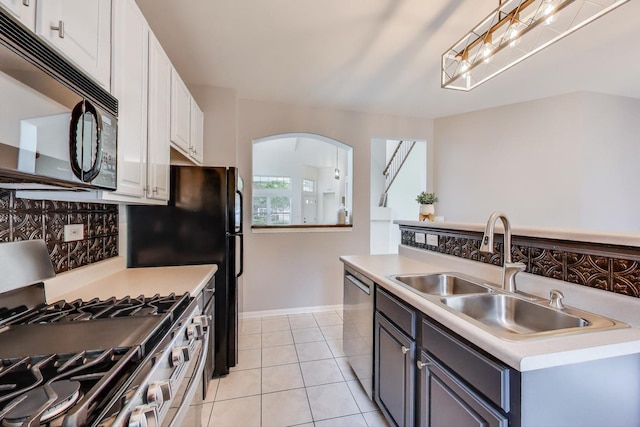 31905 Millard Cir, Warrenville, IL 60555 - kitchen featuring stainless steel appliances, a sink, white cabinets, and light countertops