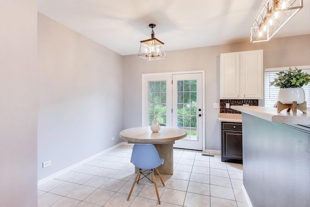 31905 Millard Cir, Warrenville, IL 60555 - dining space with a chandelier, light tile patterned floors, and baseboards