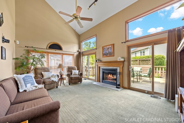 26W568 Lindsey Ave, Winfield, IL 60190 - carpeted living area featuring high vaulted ceiling, a glass covered fireplace, a ceiling fan, and healthy amount of natural light