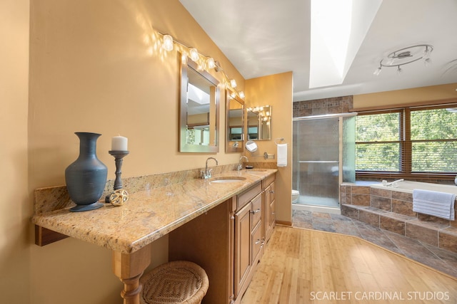 26W568 Lindsey Ave, Winfield, IL 60190 - bathroom featuring hardwood / wood-style flooring, a shower stall, toilet, vanity, and a bathtub