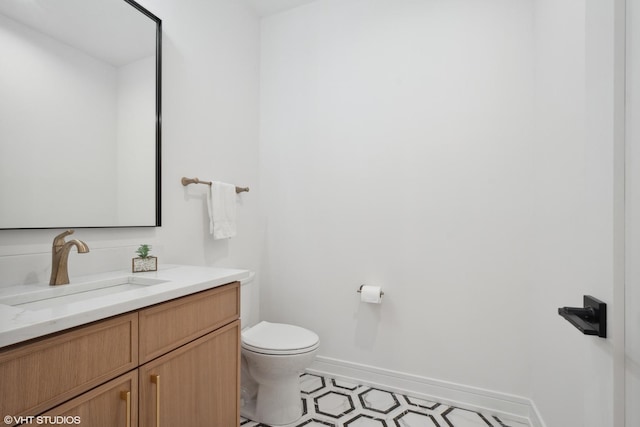 6947 N Overhill Ave, Chicago, IL 60631 - bathroom with toilet, vanity, baseboards, and tile patterned floors