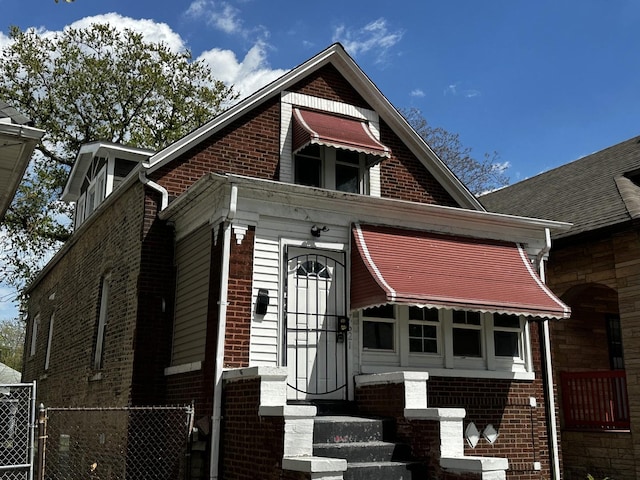 7621 S Eberhart Ave, Chicago, IL 60619 - view of front facade featuring brick siding and a gate