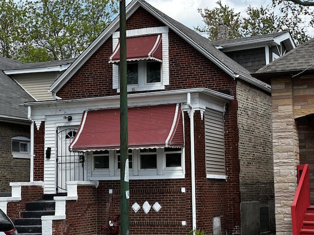7621 S Eberhart Ave, Chicago, IL 60619 - view of side of property featuring brick siding, a chimney, and a shingled roof
