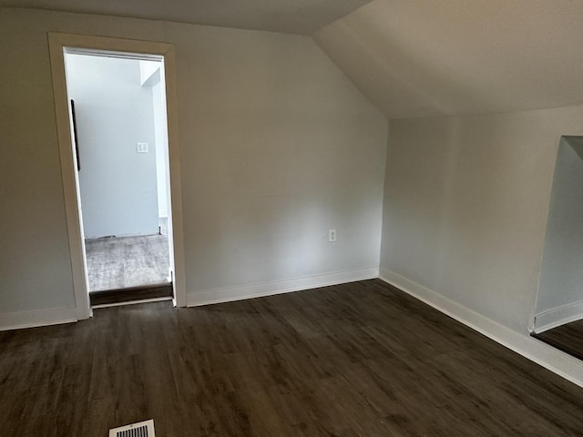 7621 S Eberhart Ave, Chicago, IL 60619 - additional living space featuring dark wood-type flooring, baseboards, and lofted ceiling