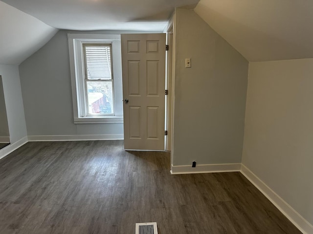 7621 S Eberhart Ave, Chicago, IL 60619 - additional living space with dark wood-style flooring, vaulted ceiling, and baseboards