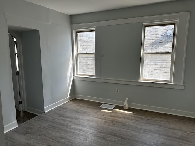 7621 S Eberhart Ave, Chicago, IL 60619 - spare room featuring baseboards and dark wood-type flooring