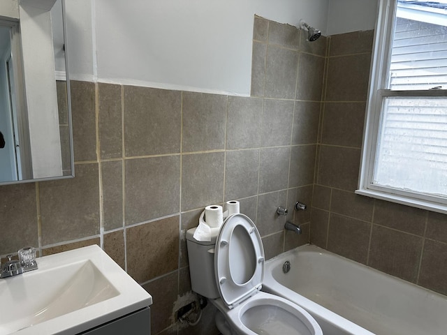 7621 S Eberhart Ave, Chicago, IL 60619 - full bath with tile walls, healthy amount of natural light, bathing tub / shower combination, vanity, and toilet