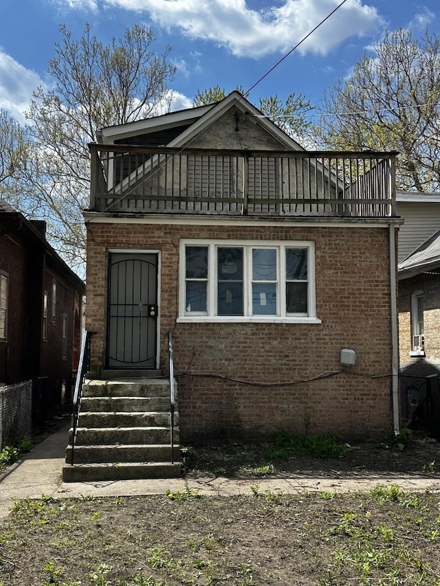 7621 S Eberhart Ave, Chicago, IL 60619 - view of front facade featuring a balcony, entry steps, and brick siding
