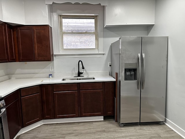 7621 S Eberhart Ave, Chicago, IL 60619 - kitchen featuring stainless steel refrigerator with ice dispenser, a sink, light wood-type flooring, and light countertops