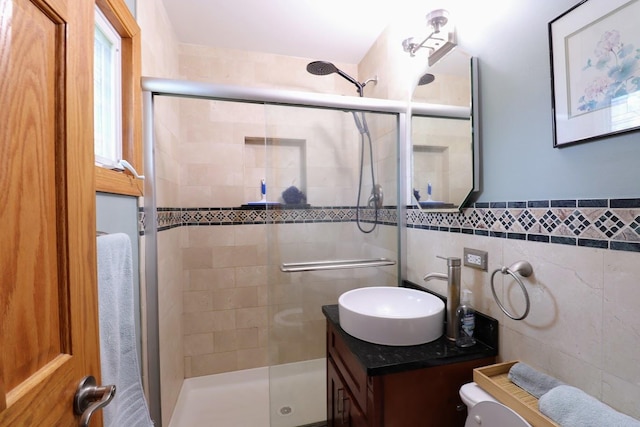80 Flagstaff Ln, Hoffman Estates, IL 60169 - full bathroom featuring a stall shower, vanity, tile walls, toilet, and a wainscoted wall