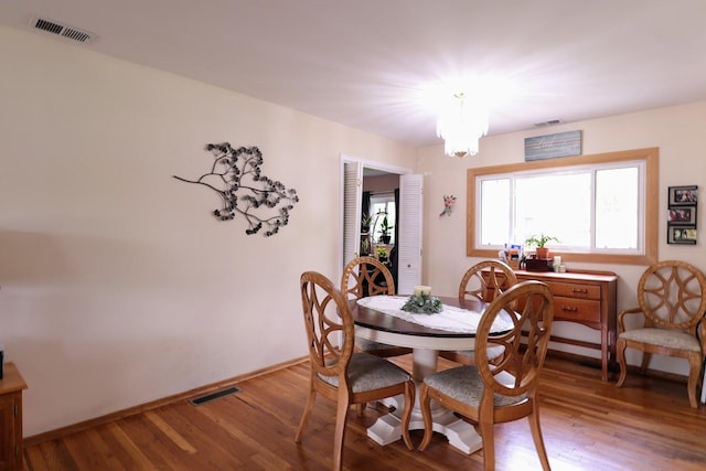 80 Flagstaff Ln, Hoffman Estates, IL 60169 - dining room with a chandelier, wood finished floors, and baseboards