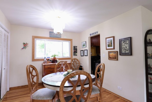 80 Flagstaff Ln, Hoffman Estates, IL 60169 - dining space with light wood-style flooring, baseboards, and a chandelier