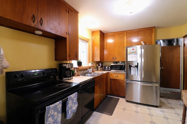 80 Flagstaff Ln, Hoffman Estates, IL 60169 - kitchen featuring black appliances, a sink, brown cabinets, light countertops, and light flooring