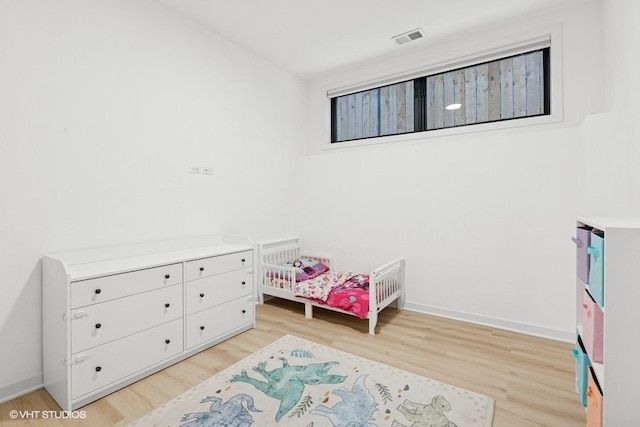 2633 N Emmett St Unit 1F, Chicago, IL 60647 - bedroom with light wood finished floors and baseboards