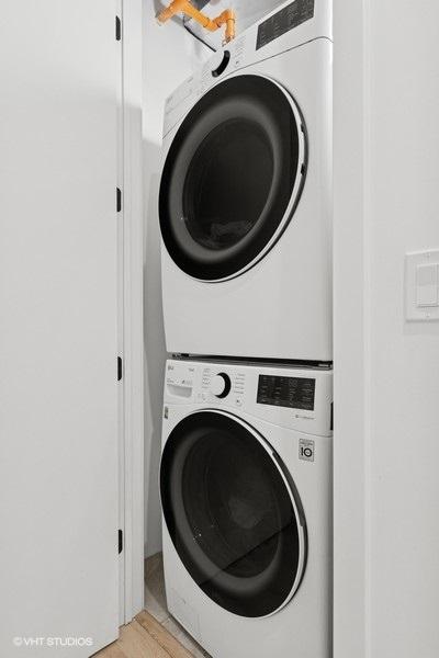 2633 N Emmett St Unit 1F, Chicago, IL 60647 - laundry room with stacked washer and clothes dryer and light wood-style floors