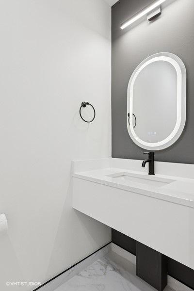 2633 N Emmett St Unit 1F, Chicago, IL 60647 - bathroom with marble finish flooring and vanity