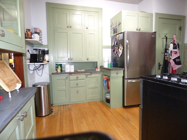 21 Woodland Ave, Elgin, IL 60123 - kitchen featuring freestanding refrigerator, green cabinets, stove, light wood-type flooring, and dark countertops