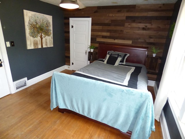 21 Woodland Ave, Elgin, IL 60123 - bedroom with wood finished floors, wooden walls, and baseboards