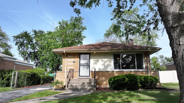 15965 Debbie Ln, South Holland, IL 60473 - view of front facade with brick siding, a chimney, and driveway