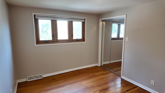 15965 Debbie Ln, South Holland, IL 60473 - unfurnished bedroom with wood finished floors, baseboards, and a closet