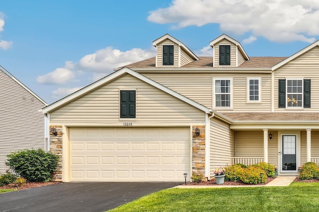 13628 Golden Grove Ave, Dyer, IN 46311 - traditional-style home with stone siding, driveway, a garage, a front lawn, and a porch